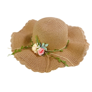 Women's foldable straw sun hat with floral decor and wavy brim for beach vacations