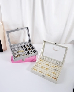 Three premium velvet jewelry boxes with glass lids showing rings and necklace sections