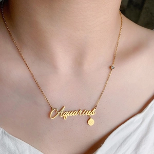 Gold Aquarius zodiac necklace with constellation charm and zircon on a woman neck