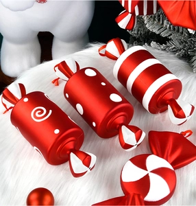 Detailed view of red and white candy ornaments with matte finish on white plush base