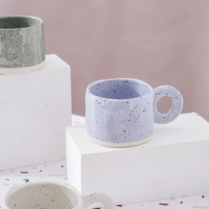 Handcrafted Nordic ceramic splash ink mugs with large ring handles on display