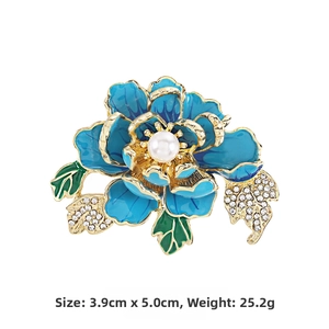 Detail of blue peony brooch with enamel petals, white pearl center and gold leaf design