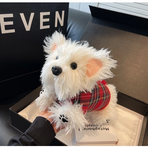 Detail of Westie plush doll wearing plaid sweater inside a premium gift box