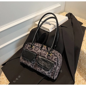 Detail of leopard print suede bowling bag with twin patent leather pockets and gold rings