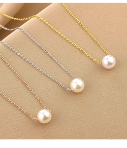 Detailed view of single pearl necklaces in gold, silver, and rose gold chain finishes