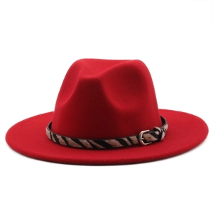 Detail of red wool fedora hat featuring zebra print band and silver metal buckle