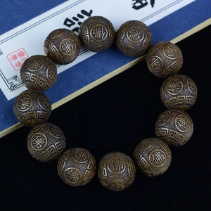 Golden Phoebe wood beads bracelet featuring Buddha carvings on aged ebony wood