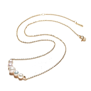 Elegant minimalist gold chain necklace with five graduated white freshwater pearls
