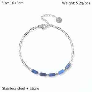 Detail of 18K gold-plated paperclip chain bracelet with blue stone beads and size label