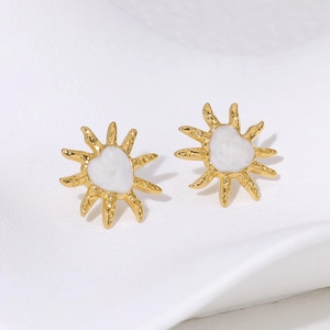 Detailed close-up of 18K gold plated sunflower earrings with white enamel center