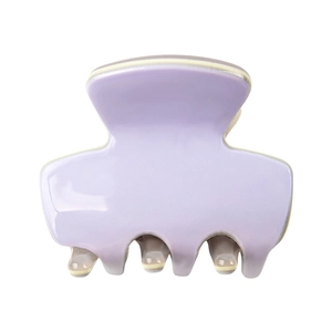 Detail of a mini light purple acetate hair claw clip with cream teeth on white background