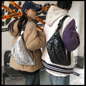 Close-up of quilted puffer crossbody bags in silver and black with street style vibes