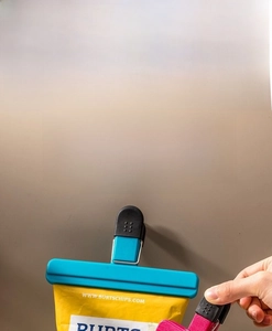 Detail of blue and pink plastic food clips sealing a bag to ensure freshness