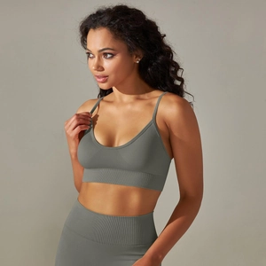 Detailed texture of seamless ribbed knit and thin straps on a grey athletic sports bra