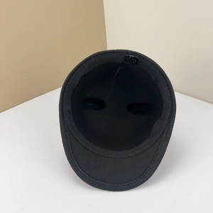 Detailed internal view of black wool felt hat showing 100% polyester lining and size tag