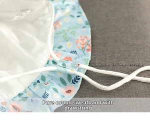 Detail of baby sun hat featuring cotton sweatband and adjustable internal drawstring