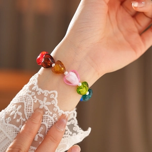 Close-up of colorful heart-shaped beads and white pearls on a stylish bracelet