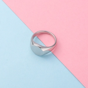 Detailed top-down view of a minimalist oval signet ring in polished stainless steel