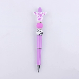 Detailed view of DIY purple beaded pen with cartoon cow head and silicone charms