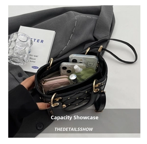 Internal capacity of black quilted crossbody bag showing space for phones and makeup
