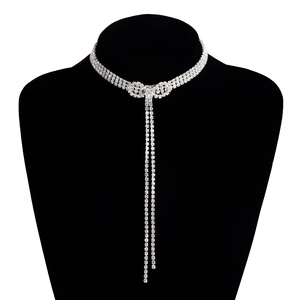 Elegant silver rhinestone choker with a bow pendant and long tassels on black velvet
