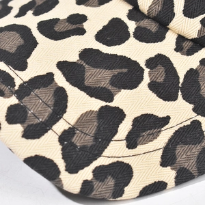 Close-up of leopard print baseball cap fabric with detailed stitching and twill texture