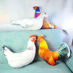 Realistic 3D printed bird plush pillows including rooster and pigeon on a sofa