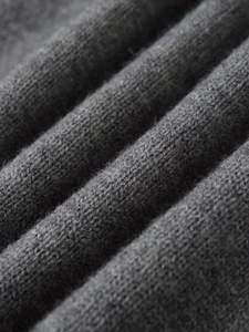 Close-up macro view of premium grey knit fabric texture with soft wool fibers