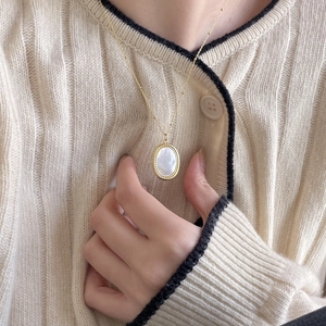 Elegant 925 sterling silver gold beaded necklace with an oval white shell pendant