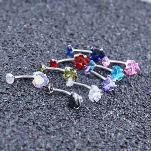 Macro view of assorted heart-shaped zircon belly rings in multiple vibrant colors