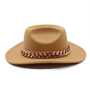 Detail of camel wool felt hat featuring a bold gold chain and wavy brim design
