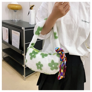 Detail of flower plush handbag featuring white and green floral pattern with colorful silk scarf