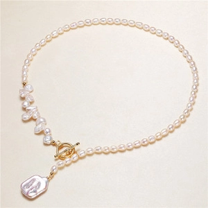 Baroque pearl necklace detail featuring golden OT clasp and large rectangle pearl pendant