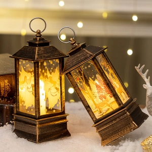 Vintage bronze Christmas lantern with angel and reindeer motifs on white snow scene