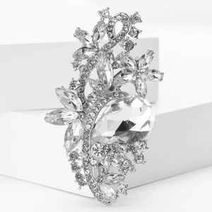 Detailed close-up of sparkling pear-cut crystals and floral rhinestones on silver brooch