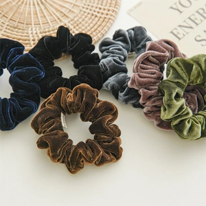 Detailed view of six-piece velvet scrunchie set in assorted elegant autumn colors