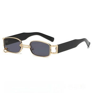 Detail view of gold metal hinges and black wide temples on cat eye sunglasses