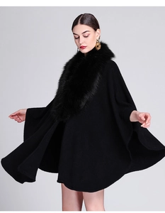 Elegant black knit poncho featuring a premium faux fox fur collar and loose fit design