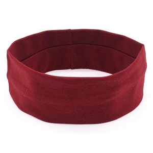 Close-up of seamless burgundy elastic yoga headband with a fine knitted fabric texture