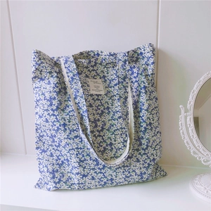 Detailed view of floral cotton tote bag with vintage mirror in aesthetic lifestyle setting