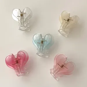 Set of five heart-shaped acrylic hair claws in assorted pastel colors for women