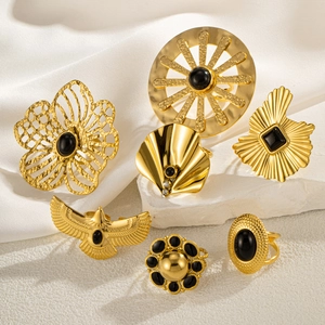 Set of seven vintage gold-finish titanium steel rings with black gemstone accents
