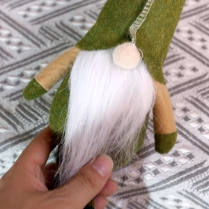 Festive green Christmas gnome doll with tall pointed felt hat and long white beard