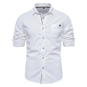 Detailed macro view of white cotton shirt texture with chest pocket and embroidered logo
