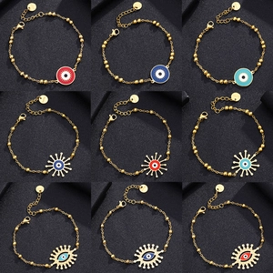 Nine assorted evil eye charm bracelets in gold stainless steel with colorful enamel motifs