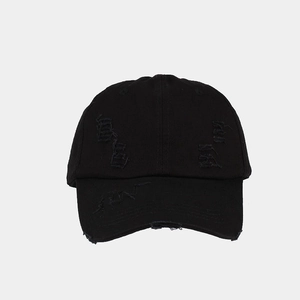 Detailed view of black washed cotton baseball cap with vintage distressed ripped holes