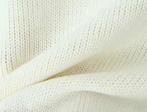Detailed close-up showing the soft knitted texture and white yarn pattern of the fabric