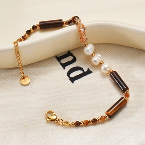 Close-up of pearl and tiger eye stone bracelet with gold S.Steel clasp and chain