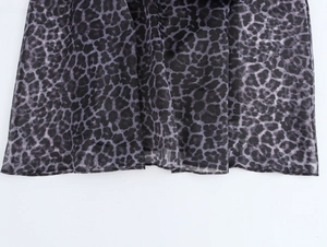 Detail of leopard print organza fabric with sheer texture and purple animal pattern