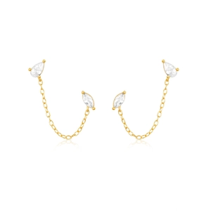 Macro shot of gold chain earrings with pear and marquise-cut white zircons on white backdrop